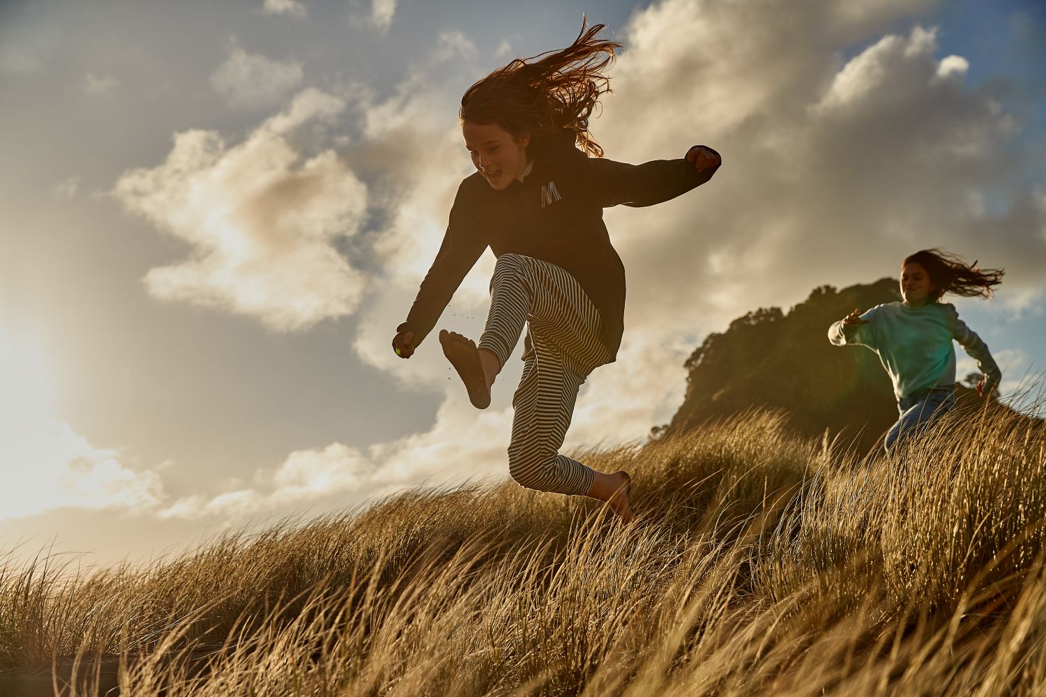 Girls running in the grass