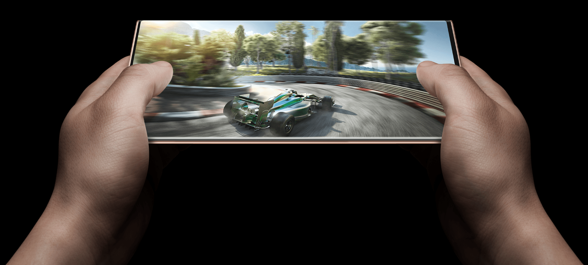 Revolutionary gaming capability with the Samsung Note20 series. A pair of hands, using a Mystic bronze Note20 device in landscape view, playing a high resolution and performance demanding car racing game. Displaying the powerful capabilities of the device.