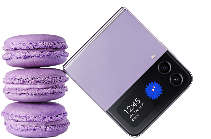 A Bora purple Galaxy Z Flip4, folded and the time and a thumbnail image displayed on the cover screen, placed next to 3 lavender purple macaroons.
