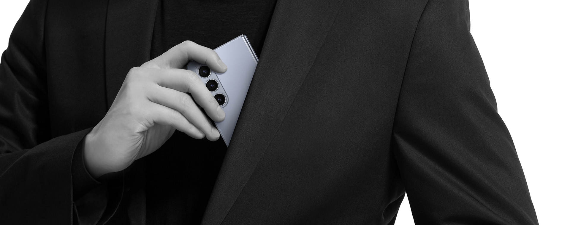 Image of a person inserting a closed Galaxy Z Fold5 into their blazer pocket