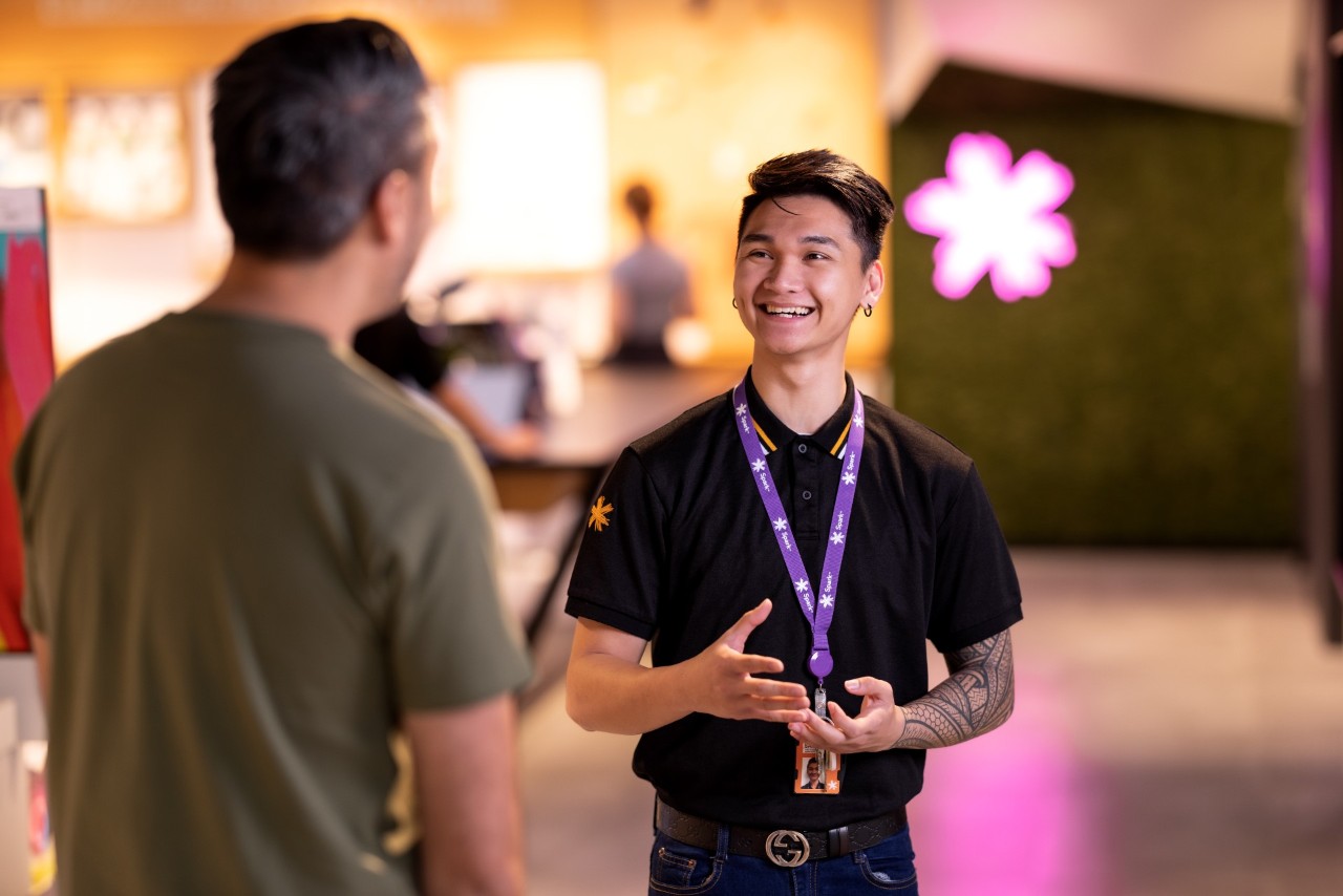 Spark store staff assists a customer