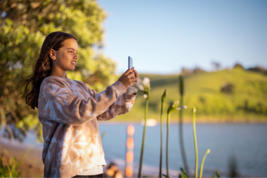 Girl taking a picture in nature